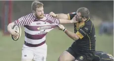  ??  ?? 0 Watsonians’ Ewan Scott is tackled by Currie’s Ross Weston.