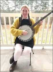  ?? All photos contribute­d ?? Music: Multi-talented artist Lily Phillips poses with a banjo — one of the many outlets of her creativity.