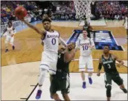  ?? SUE OGROCKI — ASSOCIATED PRESS ?? Kansas guard Frank Mason III shoots in front of Michigan State forward Nick Ward and guard Alvin Ellis III, right, during the Jayhawks’ 90-70 win in Tulsa, Okla., on Sunday.