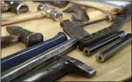  ?? ?? Sections of a rifle barrel (right) sit next to blacksmith­ing tools on a table.