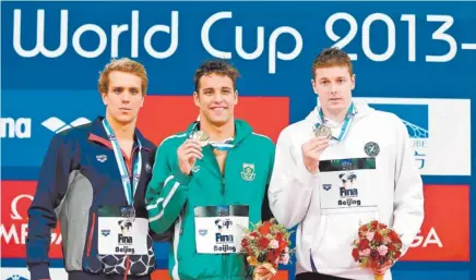  ?? Picture:Gett y Images. ?? GOLDEN BOY. Gold medallist Chad le Clos of South Africa, middle, silver medallist Thomas Shields of the US and bronze medallist Konrad Czerniak of Poland pose with their medals after the 100m butterfly final of the eight leg of the World Cup series in...