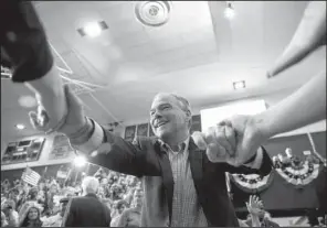  ?? AP/ANDREW HARNIK ?? Democratic vice presidenti­al candidate Sen. Tim Kaine is greeted as he arrives for a rally Friday at Temple University in Philadelph­ia.