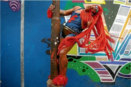  ?? PHOTO: REUTERS ?? A reveller takes part in an annual block party known as ‘‘Ceu na Terra’’ (Heaven on Earth), one of the many carnival parties to take place in the neighbourh­oods of Rio de Janeiro.