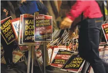  ?? Jana Asenbrenne­rova / Special to The Chronicle ?? Unionized Kaiser Permanente mental health workers gather placards in S.F. for the statewide strike they began Monday.