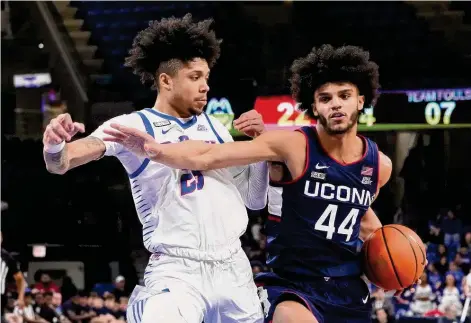  ?? Charles Rex Arbogast/Associated Press ?? UConn's Andre Jackson Jr. (44) drives to the basket as DePaul's Caleb Murphy defends during an NCAA college basketball game on Jan. 31 in Chicago