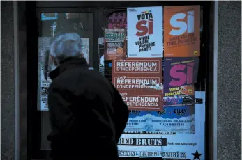  ?? AP PHOTO ?? A man walks past banners calling to vote for the referendum of independen­ce in Berga, Spain, on Tuesday.