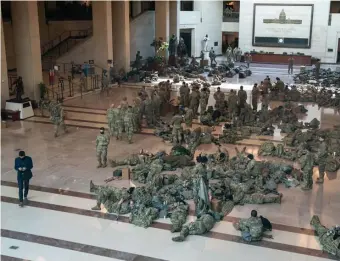  ?? LOS ANGELES TIMES ?? FORCE AT REST: National Guard members fill the Capitol Visitors Center on Wednesday. A Guard contingent from New England will cycle in for next week’s inaugurati­on of President-elect Joe Biden.