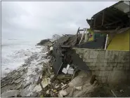  ?? JOHN RAOUX — THE ASSOCIATED PRESS ?? Parts of homes are seen collapsing on the beach due to the storm surge by Hurricane Nicole on Thursday in Wilbur-ByThe-Sea, Fla.