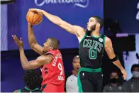  ?? AP Photo/Mark J. Terrill ?? ■ Boston Celtics’ Jayson Tatum (0) blocks the shot of Toronto Raptors’ Serge Ibaka (9) during the second half of an NBA conference semifinal Monday, in Lake Buena Vista, Fla.