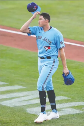  ?? TIMOTHY T. LUDWIG/USA TODAY SPORTS ?? Blue Jays starting pitcher Nate Pearson comes out of the game during a pitching change in the third inning against the Miami Marlins on Wednesday at Sahlen Field.