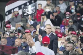  ?? CHRIS CARLSON — THE ASSOCIATED PRESS ?? Sen. Tom Tillis, R-N.C. holds a sign as President Donald Trump speaks at a campaign rally, Saturday, Sept. 19, 2020 at the Fayettevil­le Regional Airport in Fayettevil­le, N.C.