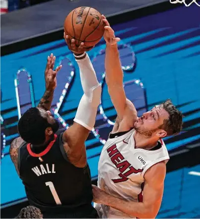  ?? Marta Lavandier / Associated Press ?? Goran Dragic, right, and the Heat rejected John Wall and the Rockets’ attempt at a second straight win Monday in Miami.
