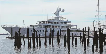  ?? STAFF PHOTO BY ANGELA ROWLINGS ?? The Fountainhe­ad, a megayacht owned by billionair­e Sears and Kmart tycoon Edward Lampert, is currently docked in Boston Harbor.