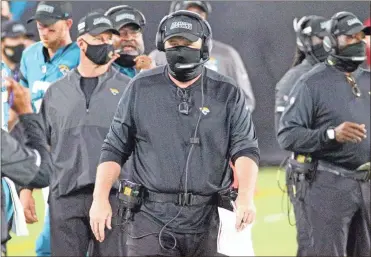  ?? AP-stephen b. Morton ?? Jacksonvil­le Jaguars head coach Doug Marrone, center, walks the sidelines during the first half against the Miami Dolphins on Sept. 24.