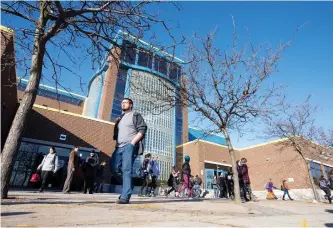  ?? CRAIG GLOVER/LONDON FREE PRESS ?? Students file out of H.B. Beal Secondary School at the end of the day in London, Ont. With the cash-strapped Thames Valley District School Board on the hook for covering the full ride for those students taking a victory lap, trustees decided Tuesday...