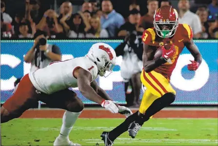  ?? Photograph­s by Luis Sinco Los Angeles Times ?? USC WIDE RECEIVER Jordan Addison, who has become a big-play threat for the Trojans this season, hauls in a catch against Fresno State in the first quarter. Addison finished with six catches for 69 yards receiving and a touchdown in the Trojans’ blowout win.