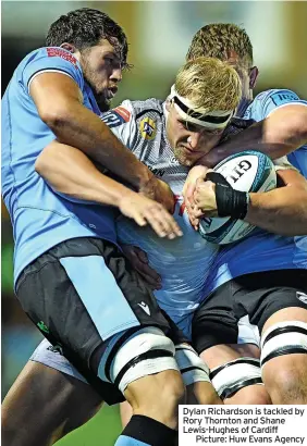  ?? ?? Dylan Richardson is tackled by Rory Thornton and Shane Lewis-hughes of Cardiff
Picture: Huw Evans Agency