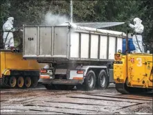  ?? MORTEN STRICKER / AFP ?? Workers disinfect a truck as Danish authoritie­s dispose of dead minks in a military area near Holstebro on Monday.