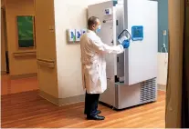  ?? PARKER MICHELS-BOYCE/WASHINGTON POST ?? Pharmacy Director Ahmed El Kority opens a new ultra freezer that will be used to store COVID-19 vaccines at the Riverside Shore Memorial Hospital in Onancock, Va.