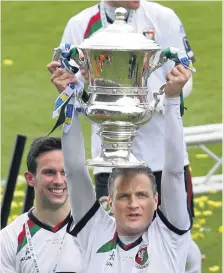  ??  ?? Colin Nixon lifts the cup for Glentoran back in 2013