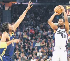  ?? — AFP photo ?? Barnes (right) of the Sacramento Kings shoots over Kevon Looney of the Golden State Warriors in the first half at Chase Centreo in San Francisco, California.