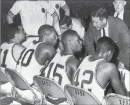  ?? THE ASSOCIATED PRESS FILE ?? Loyola coach George Ireland, right, bends over to issue orders to his team that was trailing Cincinnati in the final game of the National Collegiate basketball championsh­ip at Louisville, Ky. Players, from left to right, are: John Egan, Vic Rouse,...