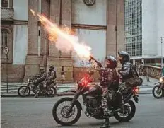  ?? AFP ?? Military police fire tear gas against protesters during the nationwide strike called by unions opposing austerity reforms in Rio de Janeiro on Friday.