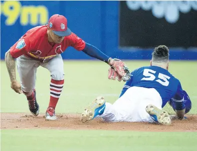  ??  ?? Toronto Blue Jays veteran catcher and Montreal native Russell Martin, sliding into second on a double in Monday’s exhibition game against St. Louis, says the Montreal games still pack excitement for him.