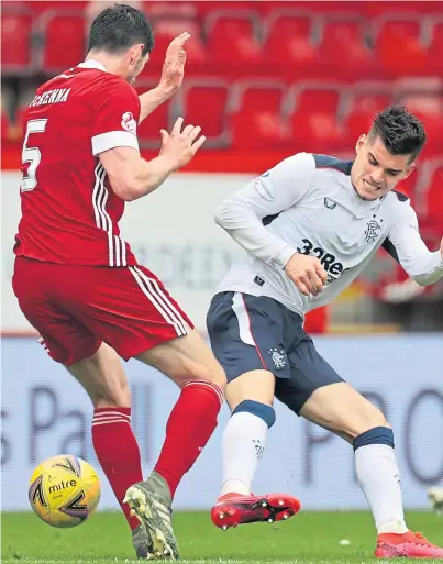  ??  ?? BACK IN ACTION: Scott McKenna in a challenge with Ianis Hagi in the season opener against Rangers