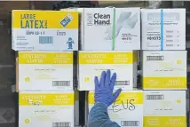  ?? Helen H. Richardson, The Denver Post ?? Dave Maddux, special projects manager for Project Cure, steadies a pallet of donated goods onto a truck during Sunday’s drive to collect personal protective equipment and other medical supplies at Empower Field at Mile High in Denver.