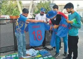  ?? AFP ?? A vendor sells World Cup merchandis­e before a World Cup match.