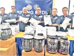  ??  ?? Abdul Latif (third left) and other Customs officers with the RM5 million worth of drugs seized in Kota Kinabalu and Sandakan.