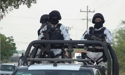  ??  ?? Members of Mexico’s national guard patrol a road in San Mateo del Mar, in Oaxaca state, after 15 inhabitant­s of an indigenous village were bludgeoned to death. Photograph: José de Jesús Cortés/Reuters