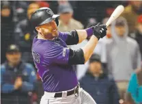  ?? Winslow Townson, The Associated Press ?? Rockies first baseman Mark Reynolds strokes what proves to be the game-inning RBI single during the 11th inning Tuesday night at Fenway Park.
