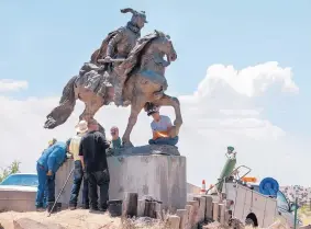  ??  ?? Workers with Rio Arriba County removed a sculpture of Juan de Oñate from the Onate Center in Acalde last week. Crowds for and against the removal lined N.M. 68 in front of the center.