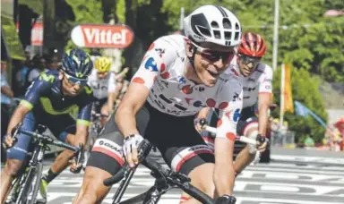  ?? Philippe Lopez, Getty Images ?? French cyclist Warren Barguil, wearing the best climber’s polka dot jersey, crosses the finish line and wins the 13th stage of the Tour de France — on Bastille Day, the country’s national holiday.