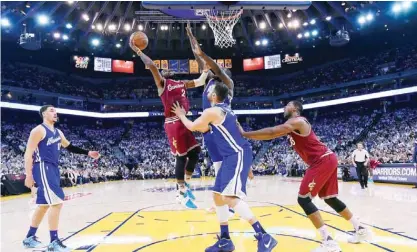  ??  ?? OAKLAND: Andrew Bogut #12 of the Golden State Warriors goes up to block the shot of Timofey Mozgov #20 of the Cleveland Cavaliers during their NBA basketball game at ORACLE Arena on Friday in Oakland, California. — AFP