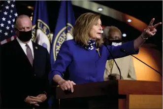  ?? (AP PHOTO/ANDREW HARNIK) ?? House Speaker Nancy Pelosi of Calif., accompanie­d by Rep. Dan Kildee, D-Mich., left, and Rep. Danny Davis, D-Ill., right, speaks at a news conference on Capitol Hill in Washington, Friday, July 24, 2020, on the extension of federal unemployme­nt benefits.