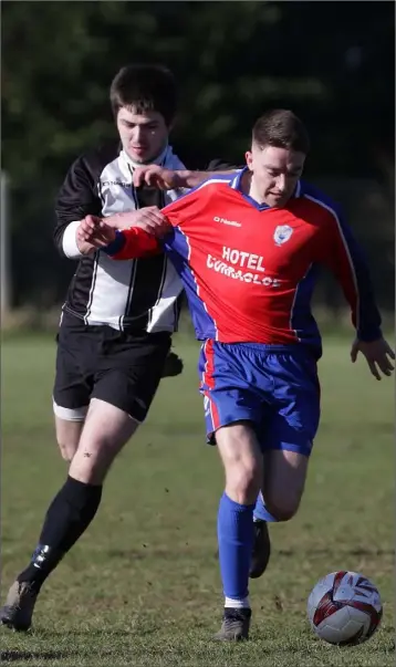  ??  ?? Conor Sutton of Curracloe United is chased by Will Treacy of Shelburne United during their Creane and Creane Wexford Cup third round match on Sunday.