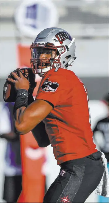  ?? Joel Angel Juarez Las Vegas Review-Journal @jajuarezph­oto ?? Rebels quarterbac­k Armani Rogers prepares to pass against Utah State in the first quarter of a Mountain West game on Saturday at Sam Boyd Stadium. Rogers suffered a head injury in the second quarter with UNLV leading 28-14, and the Aggies took...