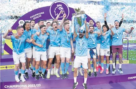  ?? ?? Manchester City’s Ilkay Gundogan lifts the Premier League trophy following the Premier League match at the Etihad Stadium.