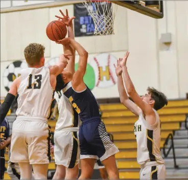  ??  ?? Blackstone Valley Prep’s Chris Rodriguez (5) is swallowed up by a trio of North Kingstown defenders during the No. 18 Pride’s 90-60 defeat to the No. 2 Skippers Thursday night in the Open state tournament. Rodriguez had nine points.