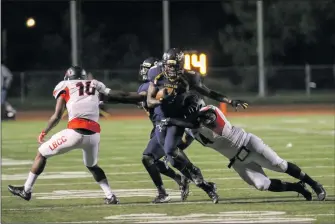  ?? Jim Bloomfield/COC Sports Informatio­n ?? Keland White attempts to break a tackle against Long Beach Community College on Sept. 23. White recorded 136 rushing yards and three touchdowns on 16 carries in helping COC to a 52-42 win.