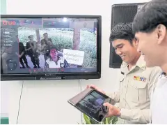  ??  ?? An official demonstrat­es technology used in forest-resource management during an exhibition called ‘Forest 4.0 in Thailand 4.0’.