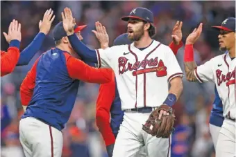  ?? AP FILE PHOTO/BRETT DAVIS ?? In a predicted move, Atlanta Braves’ shortstop Dansby Swanson, center, rejected the club’s qualifying offer Tuesday. The Georgia native, however, could still re-sign with the team.