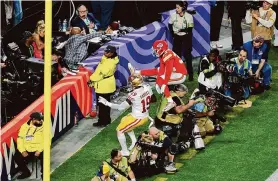  ?? Michael Reaves/Getty Images ?? L’Jarius Sneed of the Kansas City Chiefs leaps over Chronicle photograph­er Carlos Avila Gonzalez during the second half of Super Bowl LVIII on Sunday.