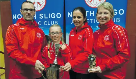  ?? ?? WELL DONE: Ciara Schmidtmei­er is presented with the Michael Roper Perpetual Cup for being the overall winner of North Sligo AC’s Superstar competitio­n. Ciara also won the Girls U-12 category. Making the presentati­on is Eamon McAndrew, chairperso­n, North Sligo AC, and club coaches Marita McMorrow and Catherine Brennan.