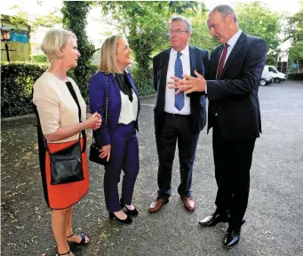  ??  ?? Fianna Fáil leader Micheál Martin with former senators Geraldine Feeney and Lisa McDonald and Senator Ned O’Sullivan; below left, mourners queue down Emmet Street, Ballina, to pay their last respects to former minister of state Seán Calleary, centre;...