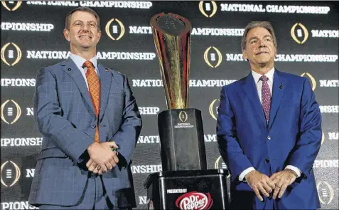  ?? BRIAN BLANCO / GETTY IMAGES ?? Clemson coach Dabo Swinney (left) and Alabama counterpar­t Nick Saban are back for another shot at the trophy after the Tigers nearly beat the Crimson Tide in the College Football Playoff final a year ago.