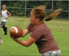  ?? Photo by Steve Sherman ?? Kacie Pinelli, 10, latches on to a pass at football camp Aug. 8 at Bristol Memorial ballfields. The camp is hosted by the borough’s 21st Century Community Learning Center.
